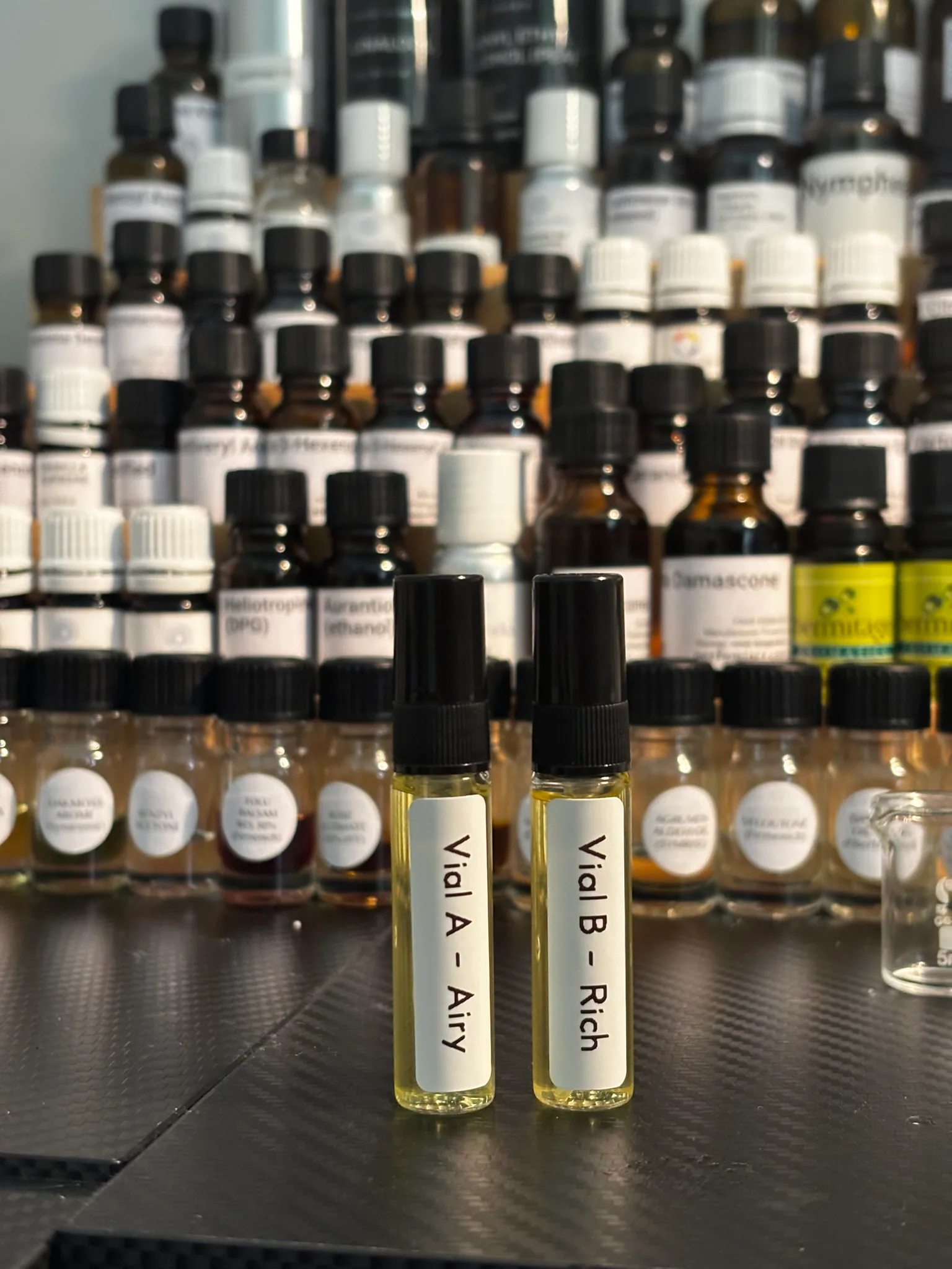 Trial vials surrounded by perfumery materials in the Avilés studio